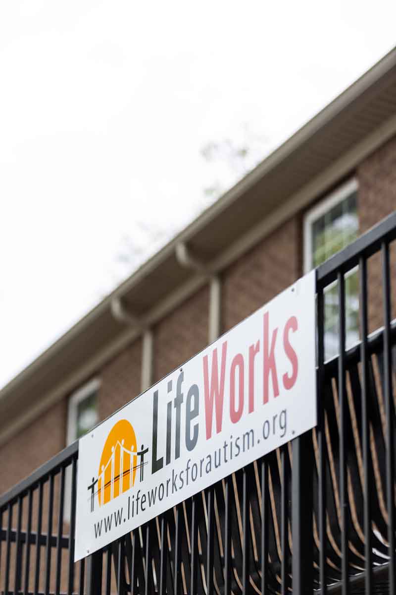 LifeWorks for Autism sign on a porch railing