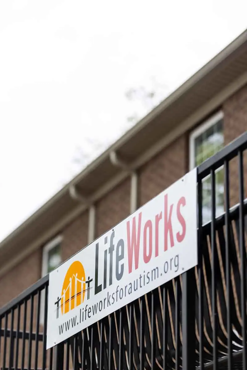 LifeWorks for Autism sign on a porch railing