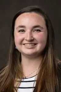 Taylor Wright Headshot on dark gray background